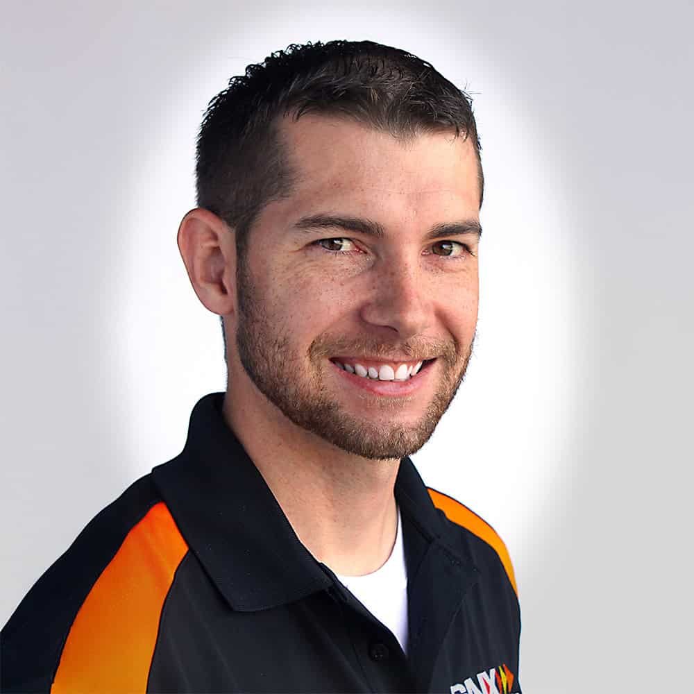 Innovative IT professional wearing SNX Technologies uniform, showcasing expertise in tech solutions and digital transformation.