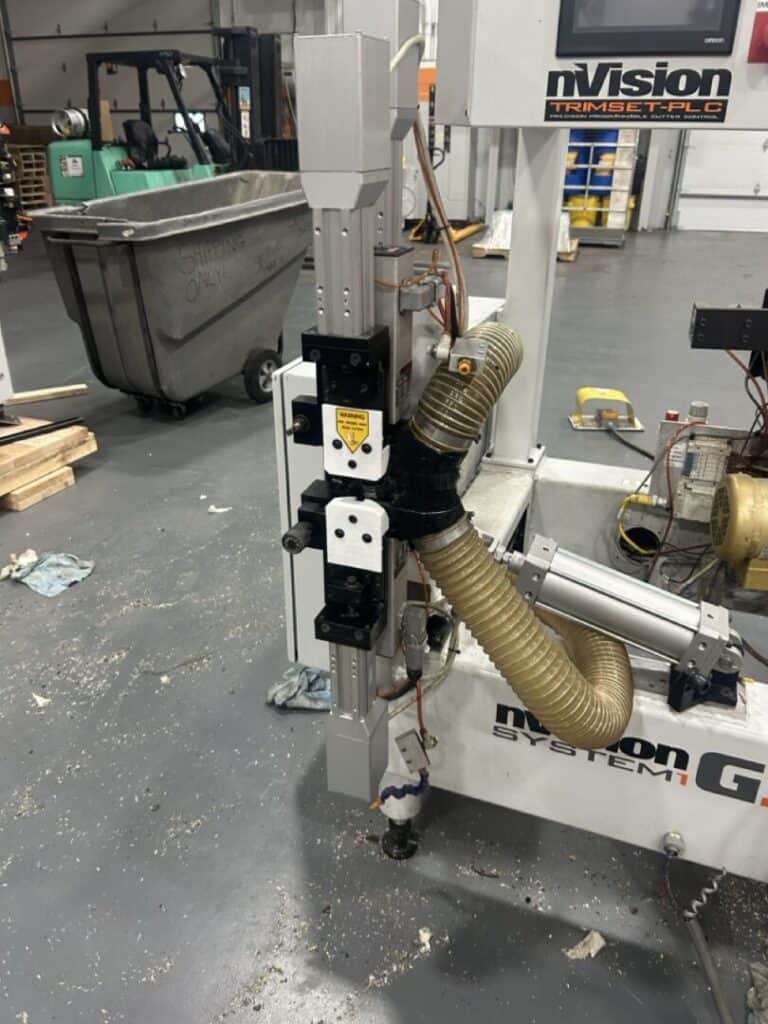 Flexible plastic ducting connected to industrial machinery for dust extraction or ventilation.