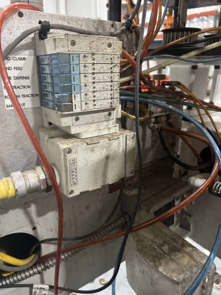 Wiring panel with electrical components and colorful wires, industrial automation equipment.