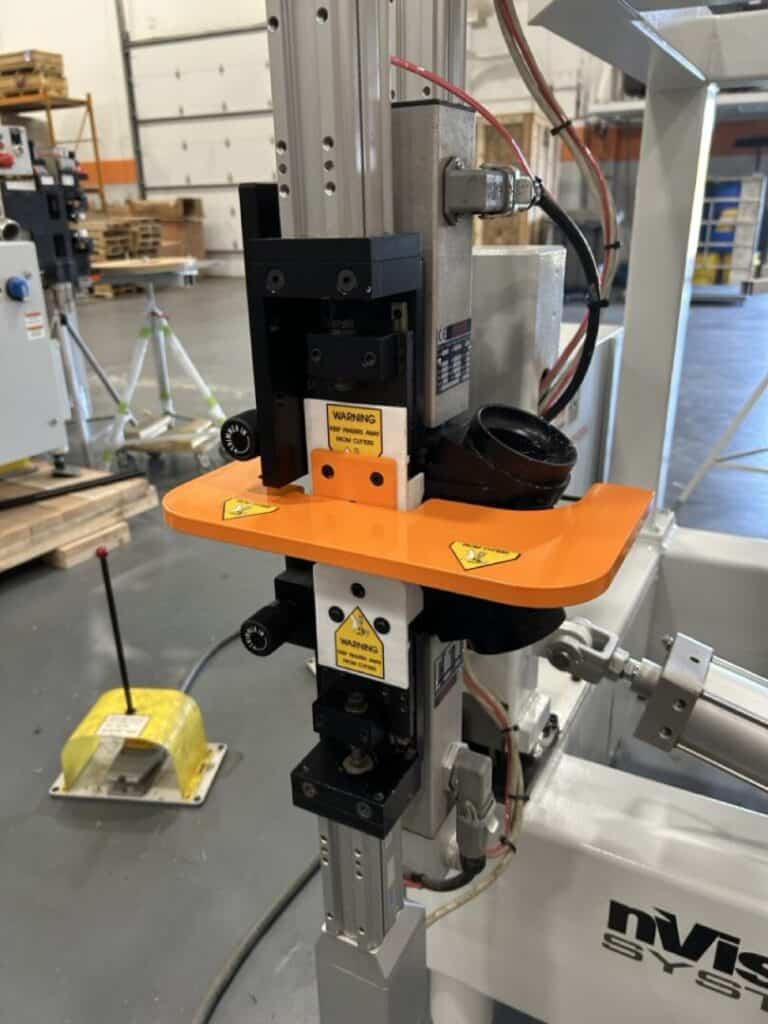 Futuristic industrial robotic tool in a manufacturing facility.