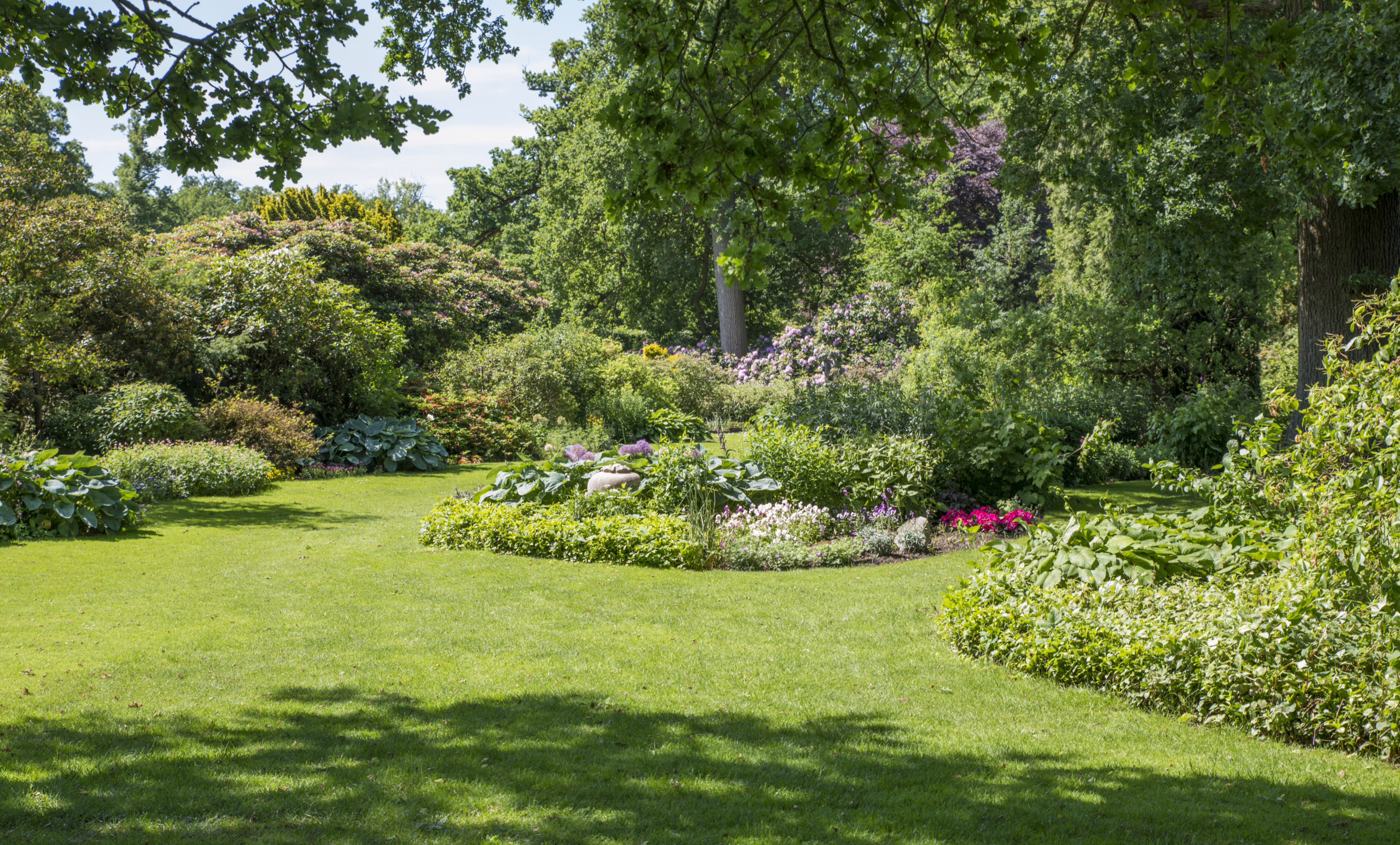 Beautiful Green english Garden Landscape with Flower Beds and T