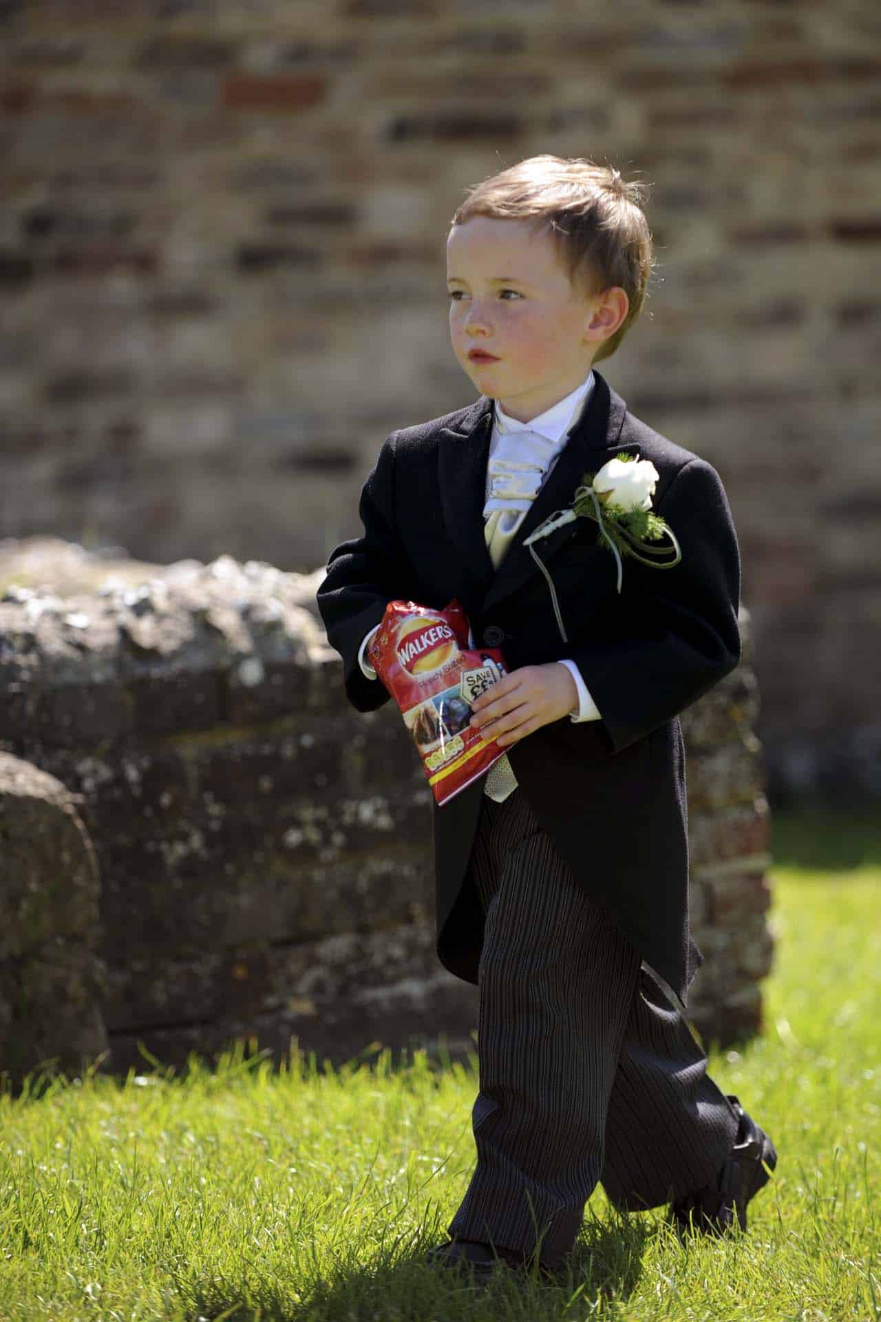 Page boy with crisps Ditchling East Sussex wedding photographer second photographer Bromley Kent