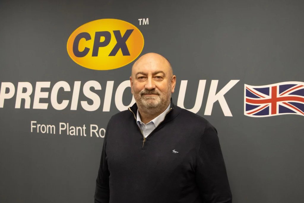Robert Sawyer standing in front of a grey wall with CPX Precision UK logo printed behind him on the wall.