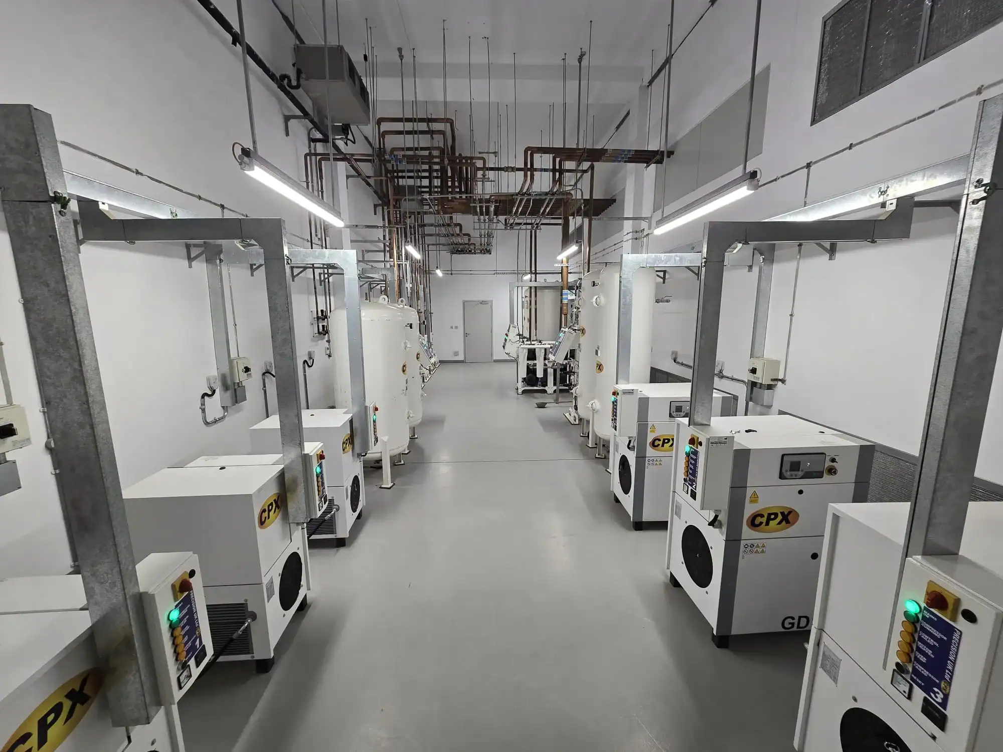Photo of a hospital plant room with various medical gas systems and pipeline network.