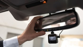 Rearview mirror with integrated dash cam for vehicle safety and recording.