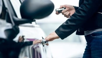 Person handing car keys to a customer at Wright ReStyling auto shop.