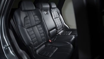 Black leather car back seats with detailed stitching for luxury comfort.