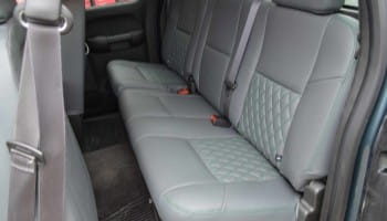 Custom gray leather car seats with quilted design for comfort and style.