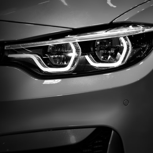 Close-up of a modern car headlight showcasing LED lighting and sleek design.