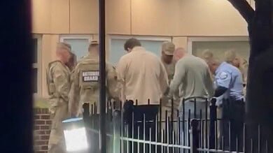 VIDEO: National Guard members, law enforcement pray outside hospital