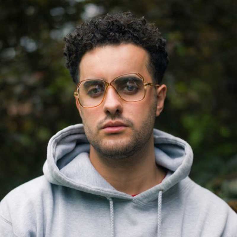 a man in a gray hoodie and glasses