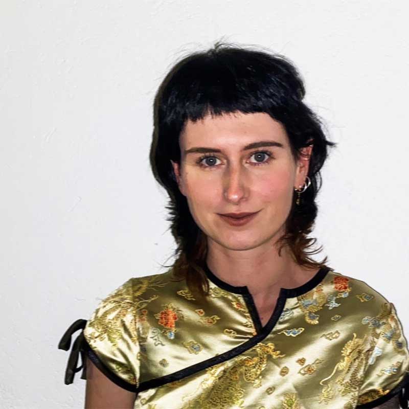 a woman in a gold dress posing for a picture