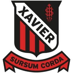 Xavier Meat Processing logo with shield and banner design for quality meat products.