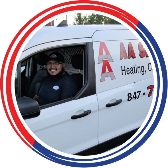 A person wearing glasses and a cap sits inside a white service van labeled "AA Service Heating, Cooling." The van is partially visible with a circular red, white, and blue border.