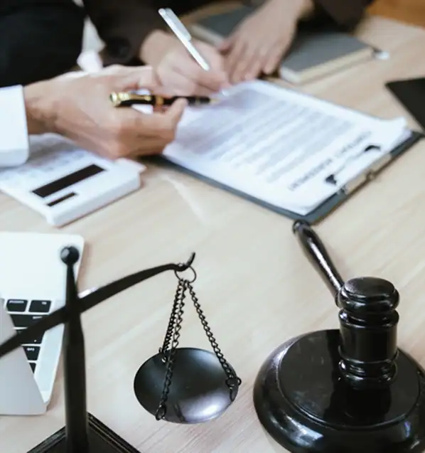 Client-Signing-A-Contract-On-A-Desk-With-A-Gavel