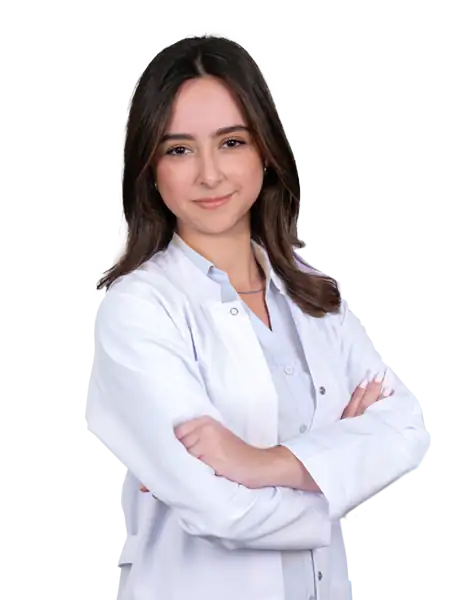 Female doctor in white coat smiling at Acibadem Hospitals Group.