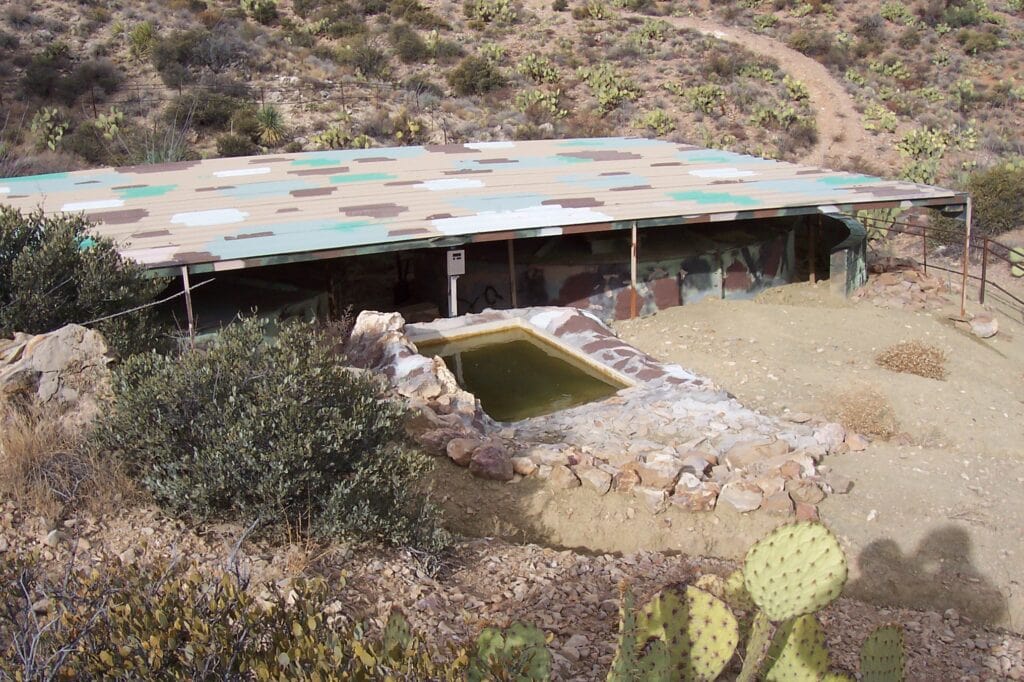 Highly detailed image of a desert sheep habitat shelter in Mesa, Arizona's arid landscape.