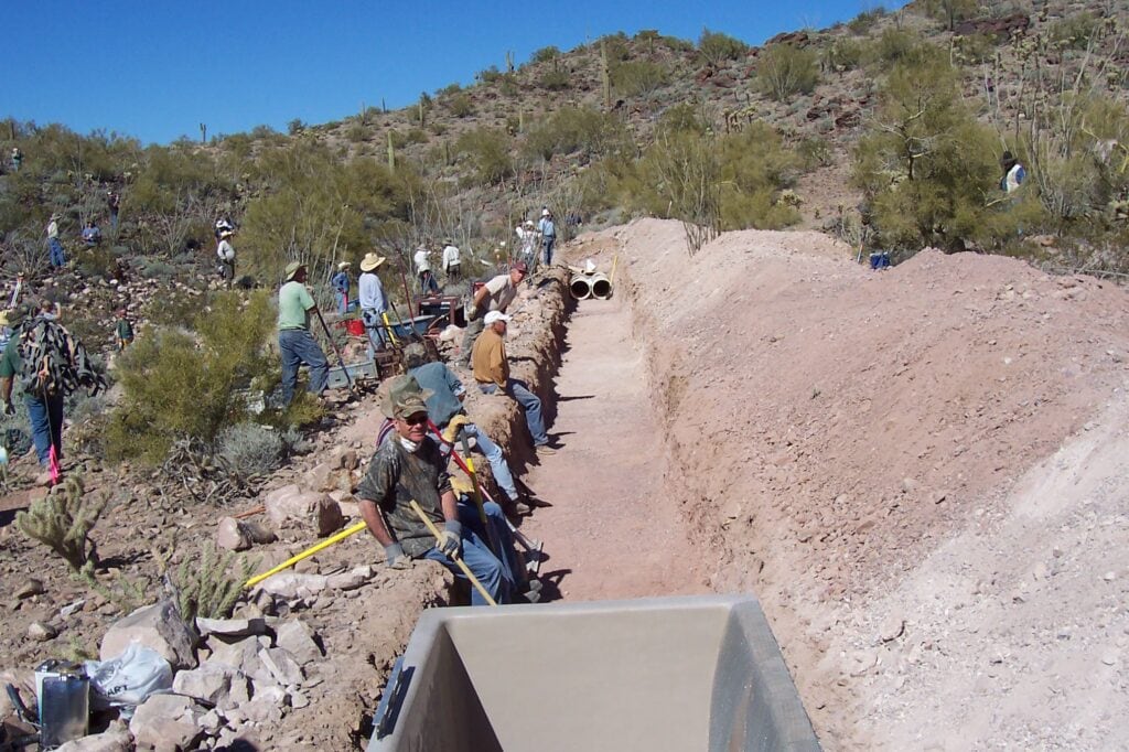 Bordered by desert vegetation and rocky terrain, showcasing Arizona's desert wildlife conservation.