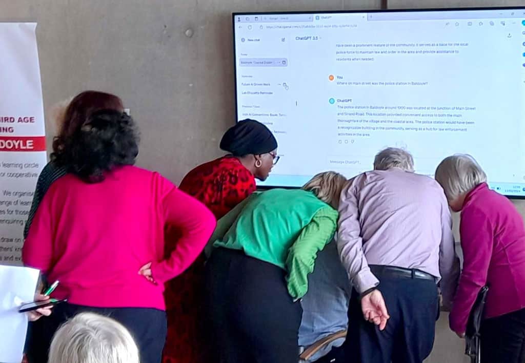 a group of people looking at a screen