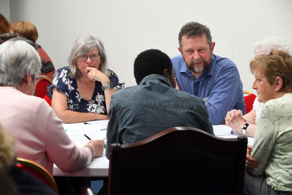 a group of people sitting around a table