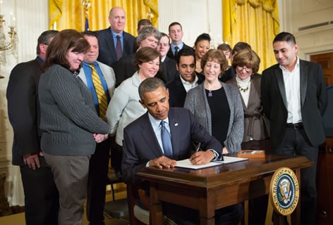 President Obama signs the presidential memorandum resulting in new rule increasing workers' overtime protections. March 13, 2014.