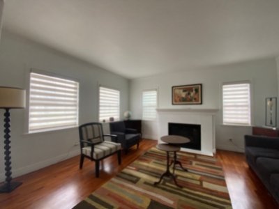 Designer banded shades installation in denver sitting room