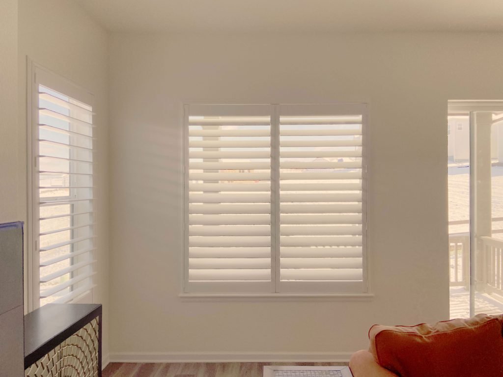 Design expert helping a homeowner choose the perfect shutters, blinds, and shades for their home