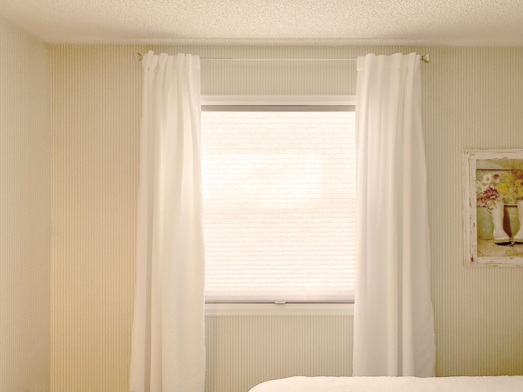 Hunter Douglas Applause Cellular Shades layered with curtains in Colorado home