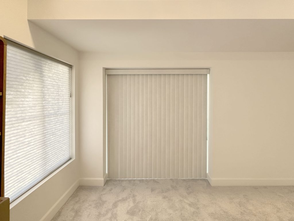 Hunter Douglas Applause Cellular Shades and Vertical Solutions Vertical Blinds with UltraGlide and wand control, left stack configuration, and light filtering fabric