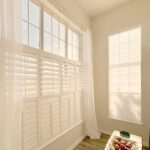 Light-filled room with sheer curtains creating a bright, airy atmosphere.