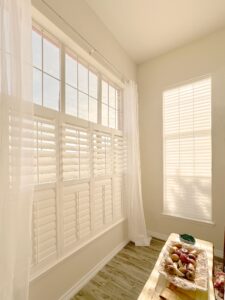 Light-filled room with sheer curtains creating a bright, airy atmosphere.