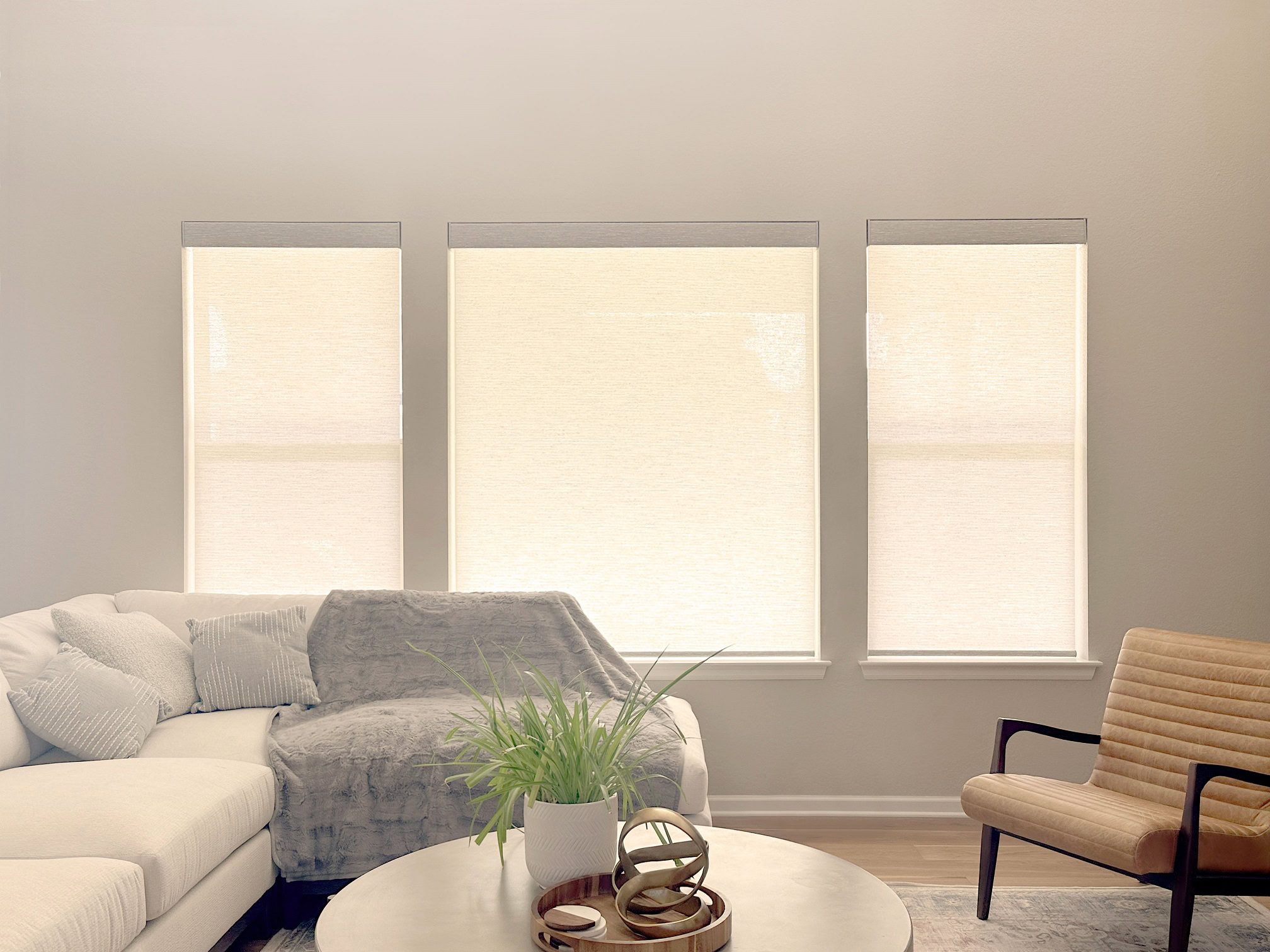 Bright living room with three large windows and comfortable furniture in Denver.