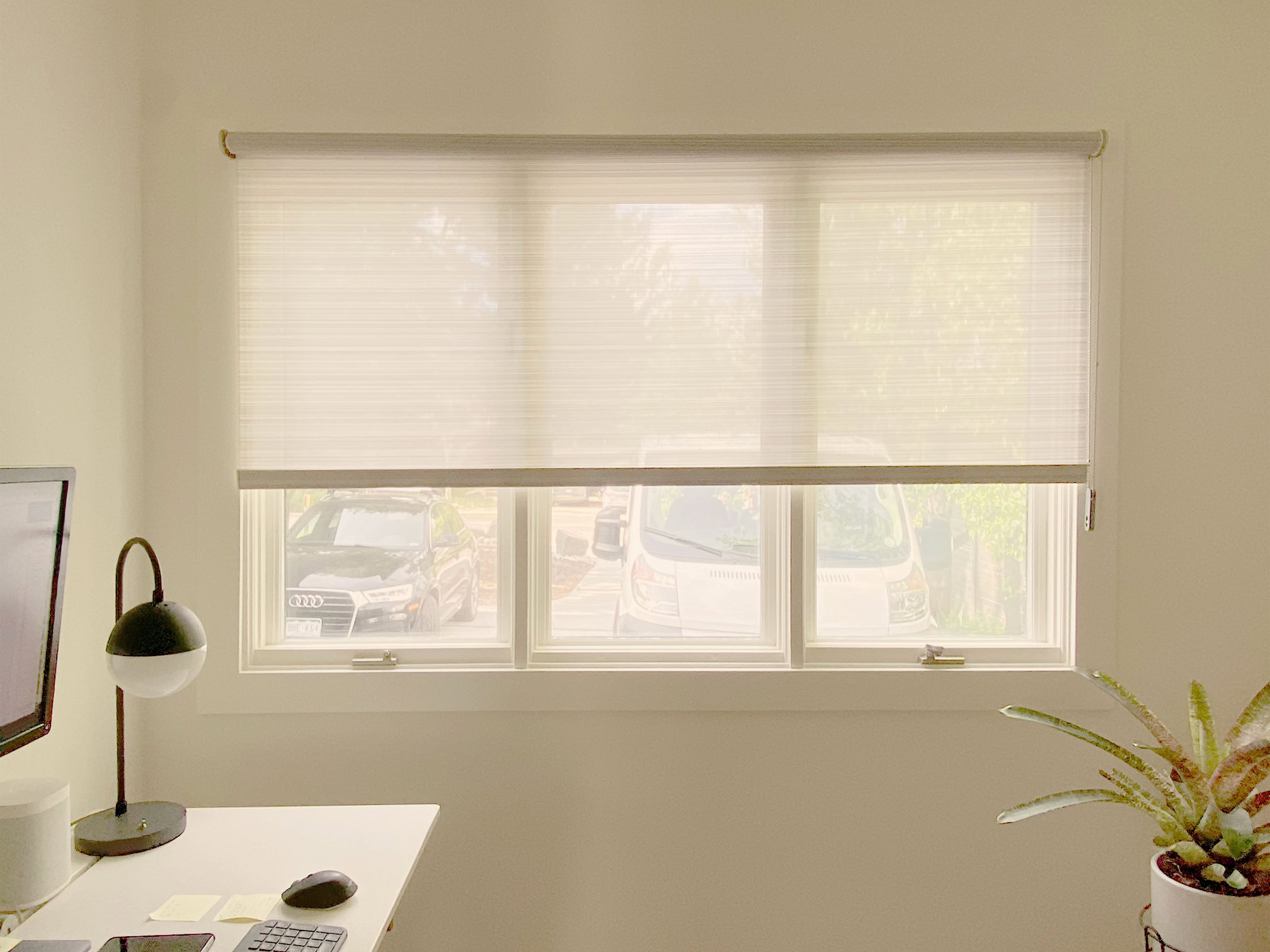 Bright window with white blinds in a modern home.