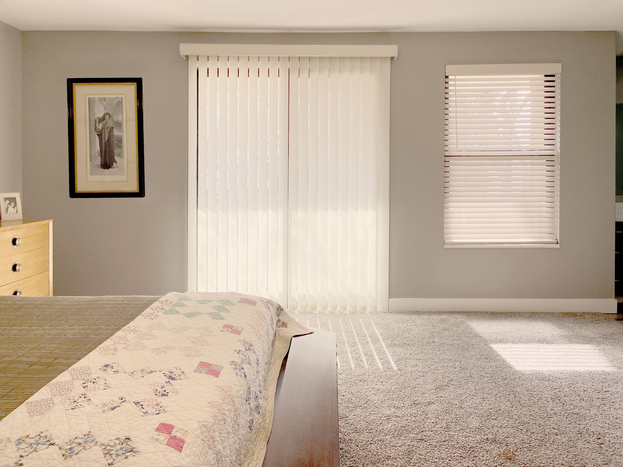 Modern vertical blinds covering bedroom sliding door and window.