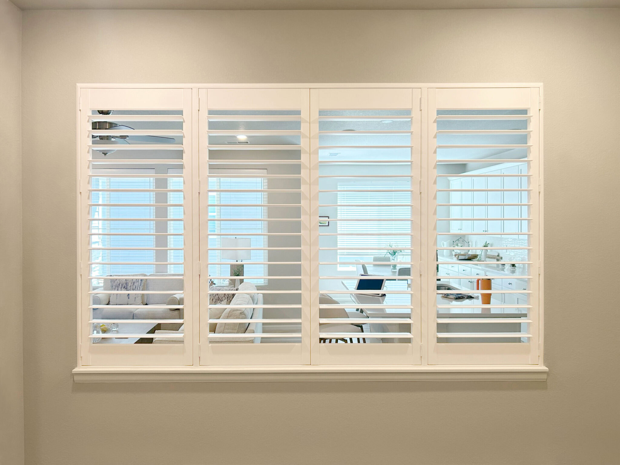 Hunter Douglas Parkland Natural Wood Blinds with SimpleLift operation paired with Palm Beach Polysatin Shutters featuring hidden tilt and Z frame