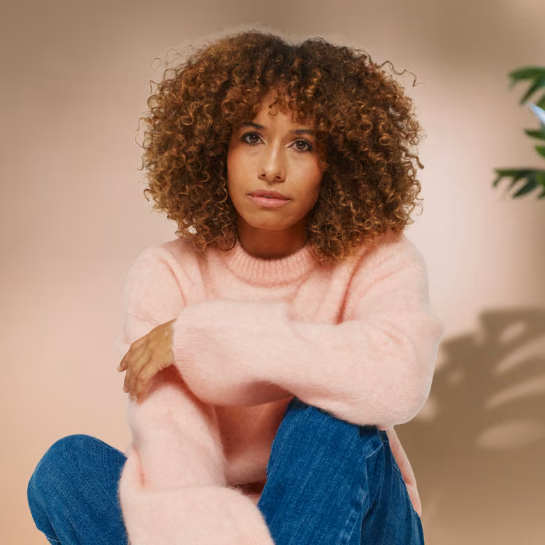 Woman experiencing digestive discomfort, representing gut health issues, hormone changes, and stress-related digestive symptoms in women.