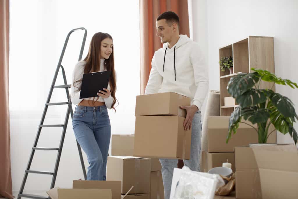 Man and woman packing boxes for moving in Airdrie home.