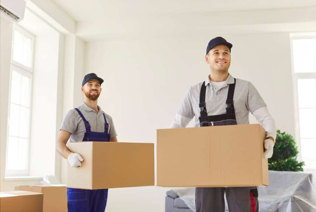 Movers in Cochrane carrying boxes for a move with All Day Movers.