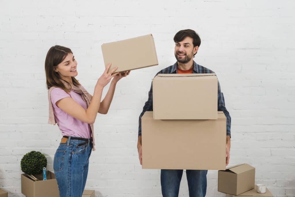 Young couple moving boxes during a relocation in High River.