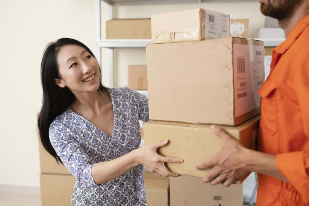 Woman receiving boxes from mover during a professional move in Langdon.