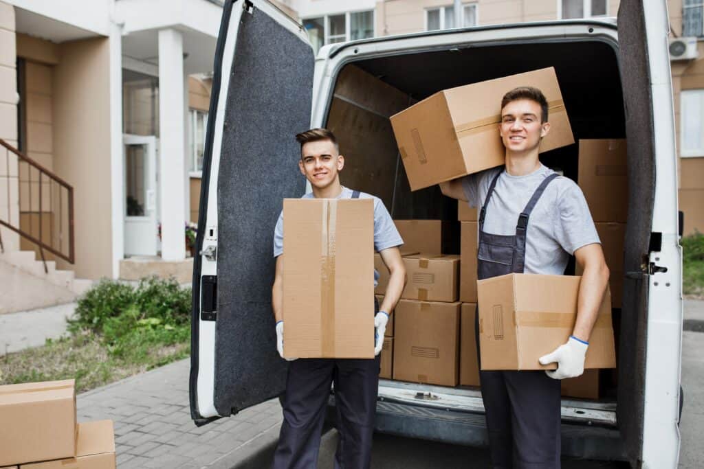 Movers loading boxes into a van for local Edmonton move.