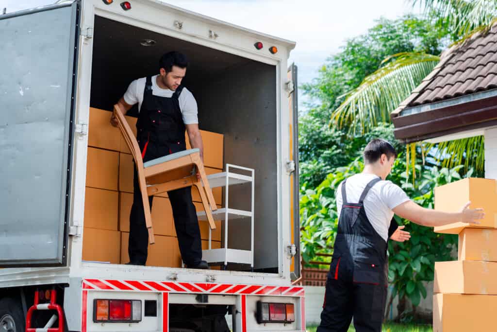 Movers loading boxes into a truck for local relocation in High River.