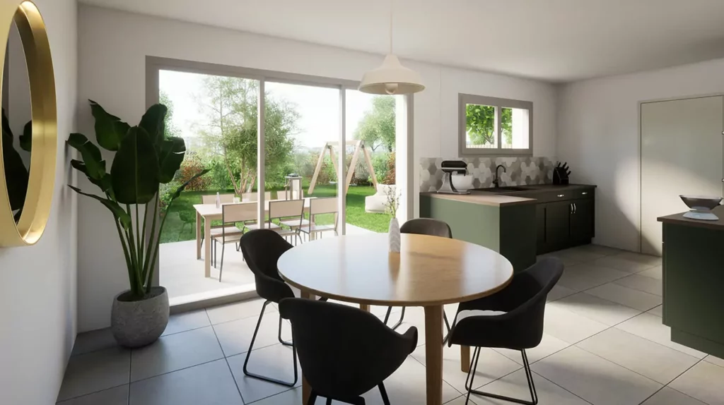 Cuisine ouverte et lumineuse avec mobilier vert foncé, table ronde en bois, et vue sur le jardin verdoyant à travers de grandes baies vitrées.