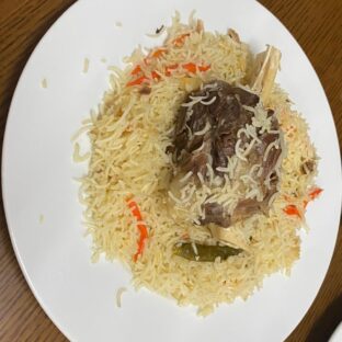 Lamb Shank Biryani with tender lamb, saffron rice, and caramelized onions