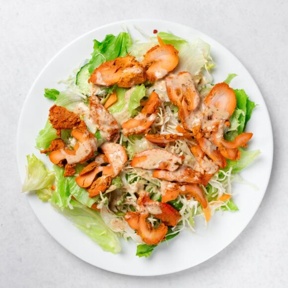 Chicken Tikka Salad with grilled chicken, fresh lettuce, cucumbers, onions, and tomatoes