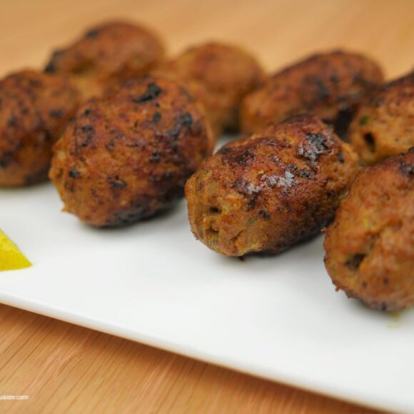 “Juicy Gola Kabab served with naan, salad, and chutney