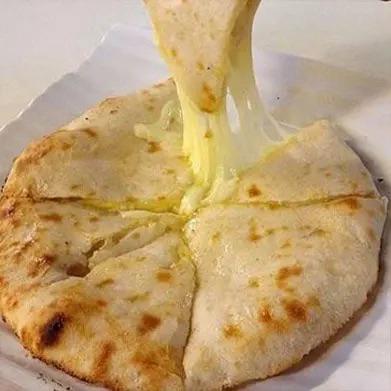 Cheese Naan stuffed with melted cheese, baked fresh at Ammonight Restaurant Japan