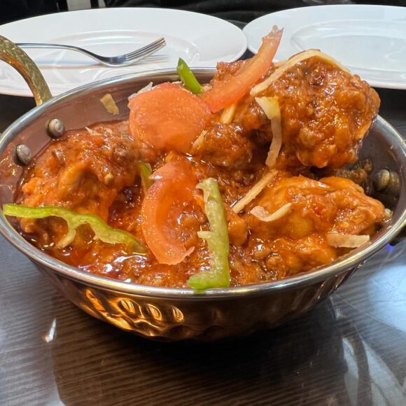 Chicken Karahi served at Ammongt Restaurant – authentic Halal food with naan and salad
