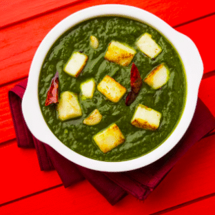 Palak Aloo curry with spinach and potatoes served with naan and rice
