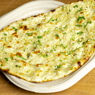 Garlic Naan freshly baked in tandoor with garlic butter and herbs